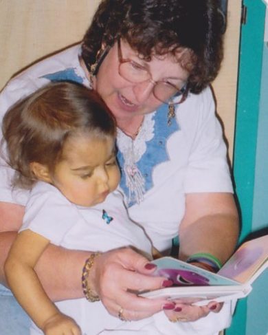 Marilynn Zeljeznjak reading to her granddaughter, Sarah.