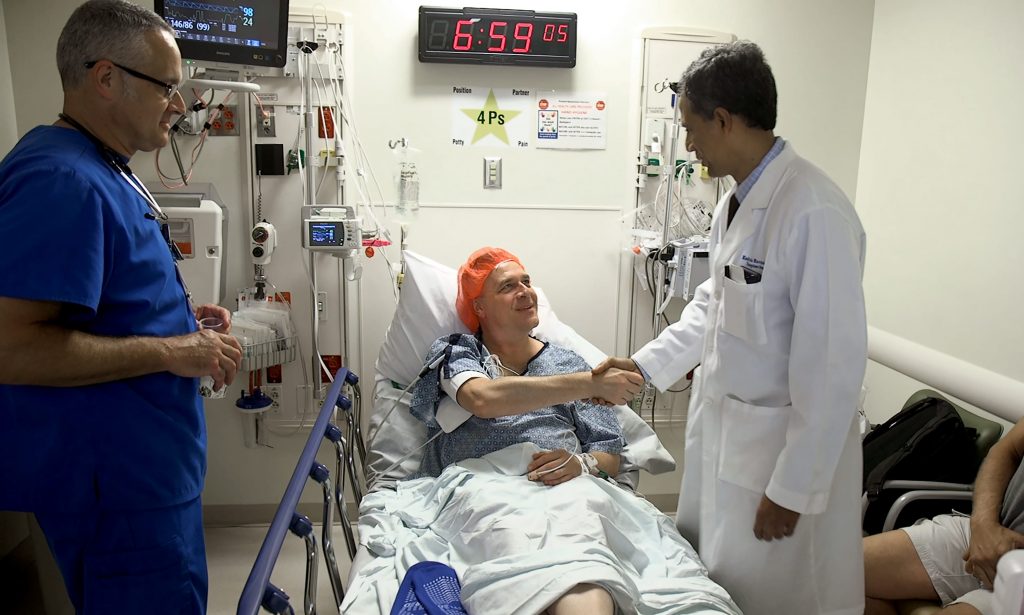 Karl Neumann meets Dr. Kadiyala Ravindra in pre-op before donating a kidney. Photo Courtesy: Shawn Rocco/Duke Health