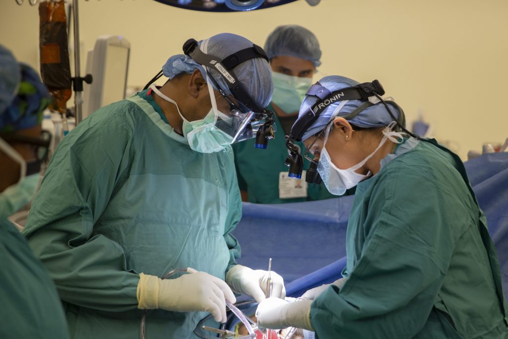 Surgeons Bradley Collins, left, and Aparna Rege prepare the anonymous recipient for the kidney transplant. Photo Courtesy: Shawn Rocco/Duke Health