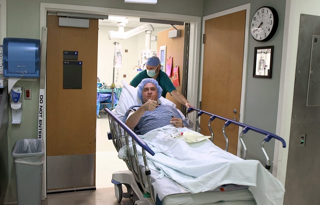 Karl gives a "thumbs-up" while heading into the operating room to donate a kidney. Photo Courtesy: Shawn Rocco/Duke Health