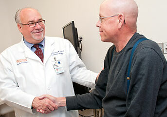 Dr. Kenneth Brayman with a patient. Courtesy of UVA Health System.