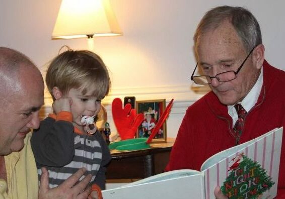 Jim Price reads "The Night Before Christmas" to his young grandson.